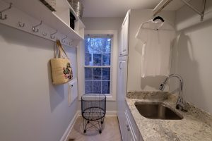 white high-end laundry room cabinetry